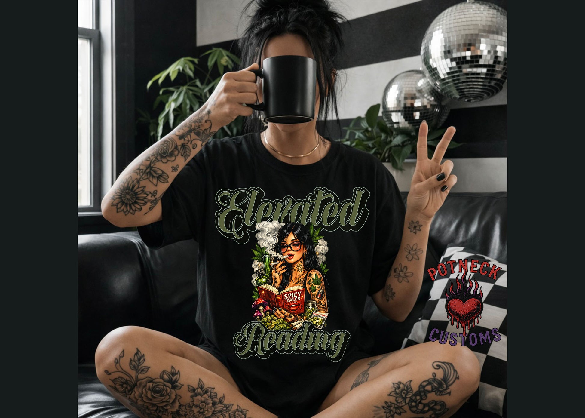 Person wearing a black t-shirt with a graphic design, sitting in a room with decorative elements.